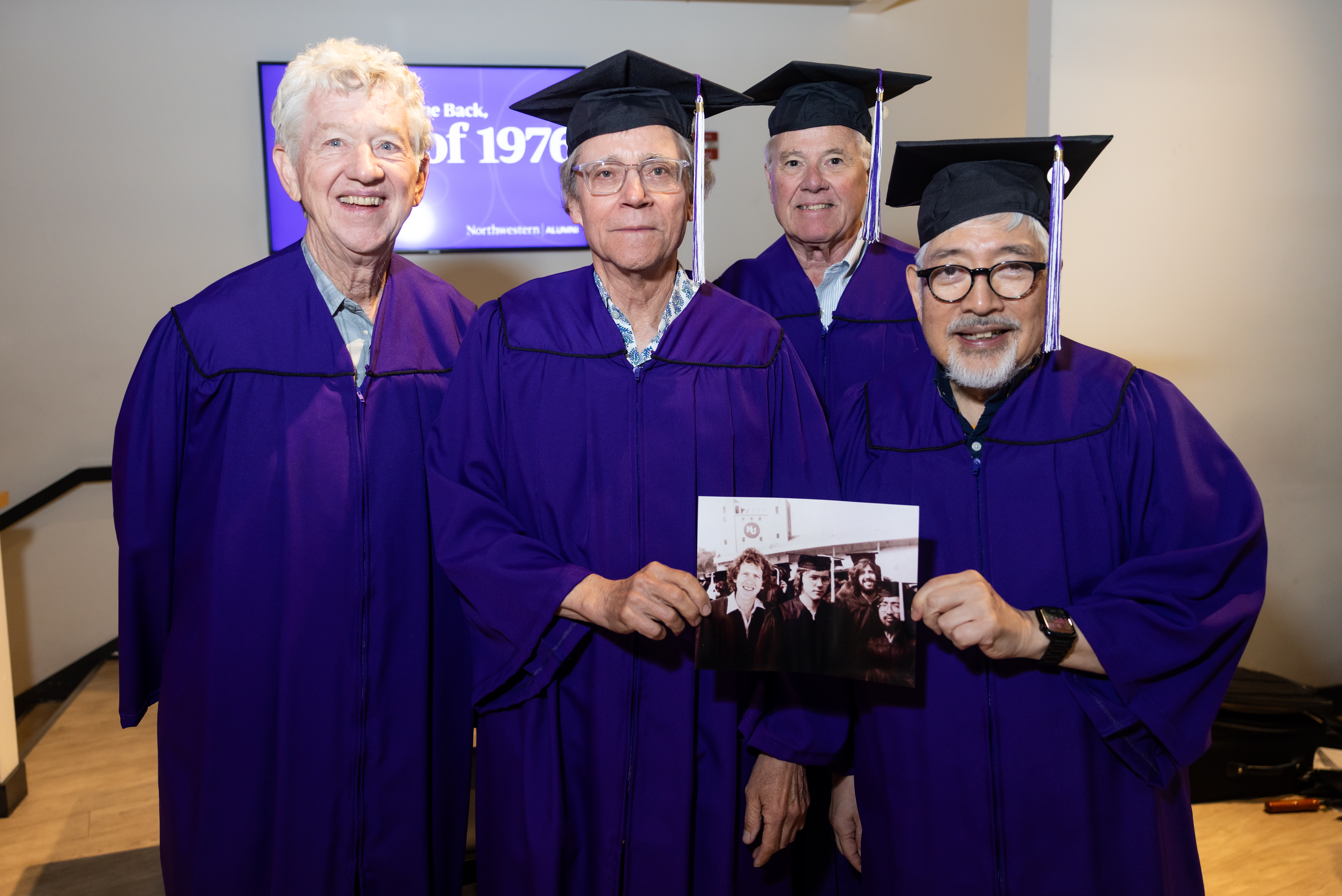 Four alums smiling 