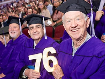 1976 alums sitting at commencement