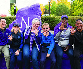 Group of people posing by the Rock